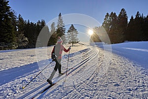 Woman cross-country skiing short before sunset in the Bregenz Forest Mountains