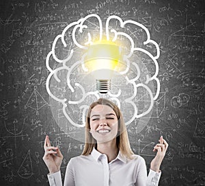 Woman with crossed fingers and light bulb with brain and formula