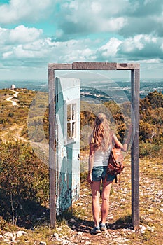 woman crossing open door in the nature