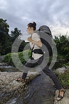 Woman crossing the stream