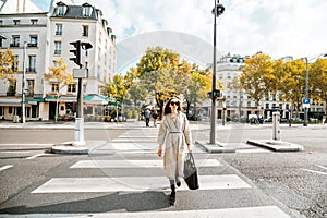 Woman crossing the street in Paris