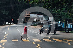 Woman crossing the street at a pedestrian crossing