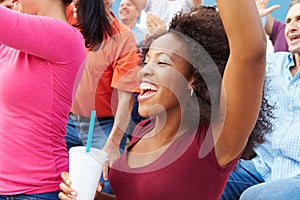 Woman In Crowd Celebrating At Sports Event