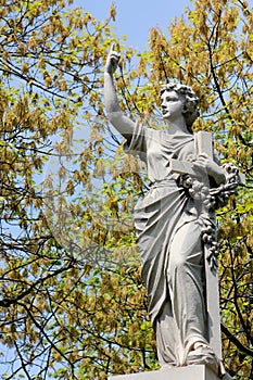 Woman with Crucifix and Floral Wreath Statue photo