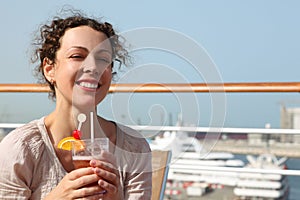 Woman on cruise liner with cocktail