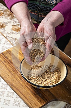 Woman crushing nuts for baking