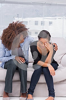 Woman crying next to her therapist