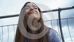 Woman crying, sitting on street, breakup loss of close person, mental disorder