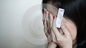 Woman is crying with stress after her test results showed positive. She was covid-19 infected