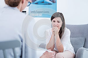 Woman crying during therapy at a family support center