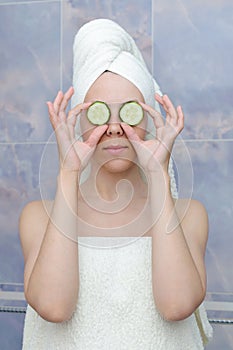 Woman with a cucumbers on eyes