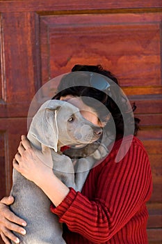 Woman cuddling pet dog