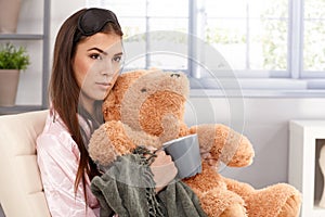 Woman cuddling with teddy bear