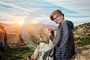 Woman with cup of coffee enjoying on mountain