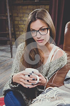 Woman with cup of hot drink. Dream and relax