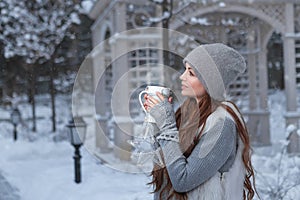 Woman with cup of tea in a park