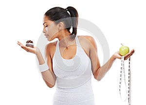 Woman, cupcake and choice or fruit decision in studio healthy, nutrition benefits or weight loss. Female person, dessert