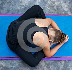 woman curled up in bound angle forward fold