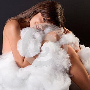 Woman Curled Up With Fluffy Cotton