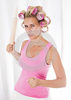 Woman with curlers and a rolling pin