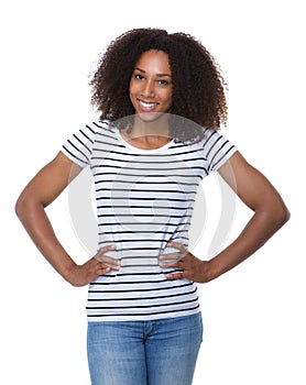 Woman with curly hair smiling with hands on hip