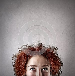 Woman with curly hair thinking