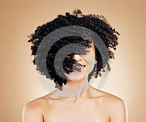 Woman, curly and hair wind in afro fun on studio background for healthy hairstyle growth, texture and frizz treatment