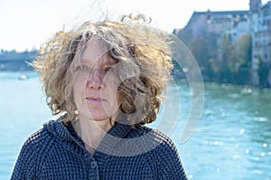 Woman with curly tousled hair outdoors