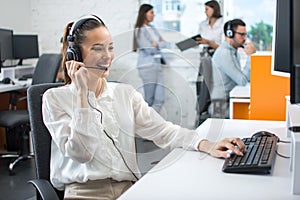 Woman customer service worker, call center smiling operator with phone headset working in office