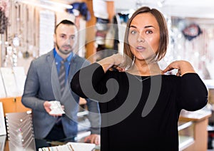 Woman customer trying chainlet with pendant