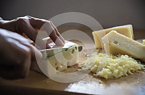 Woman cut slice cheese for cook using knife in the kitchen