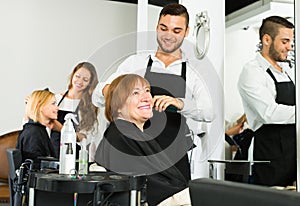 Woman cuts hair at the hair salon