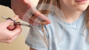 woman cuts little girl's wet hair. cutting hair at home.