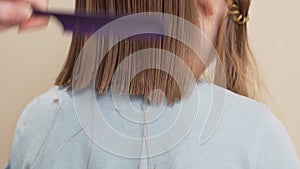 woman cuts little girl's wet hair. cutting hair at home.