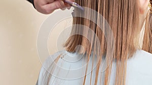 woman cuts little girl's wet hair. cutting hair at home.