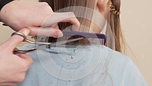 woman cuts little girl's wet hair. cutting hair at home.