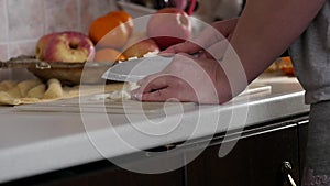 Woman cuts onions on a wooden board. slow motion