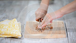 Woman cutting almonds. Healthly food.