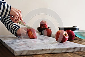 Woman cutting apples on the table