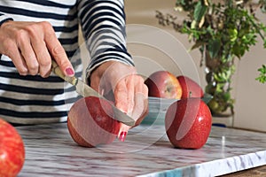 Woman cutting apples on the table