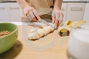 Woman cutting a banana for breakfast.