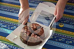 Woman cutting Chocolate Cake in Slices