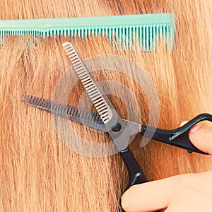 Woman cutting down smoothy hair.