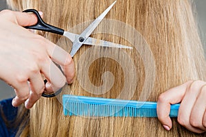 Woman cutting down smoothy hair.