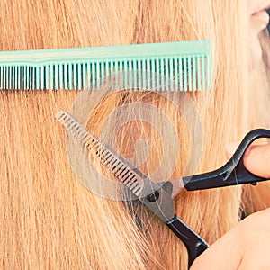 Woman cutting down smoothy hair.