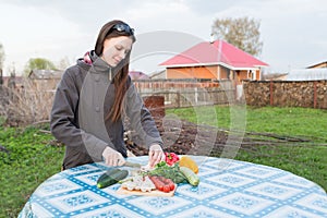 Woman cutting fresh vegetables