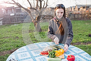 Woman cutting fresh vegetables