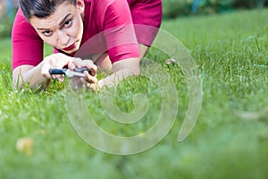 Woman cutting a grass using a scissors