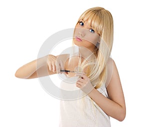 Woman cutting her hair with scissors