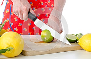 Woman cutting a lime in half